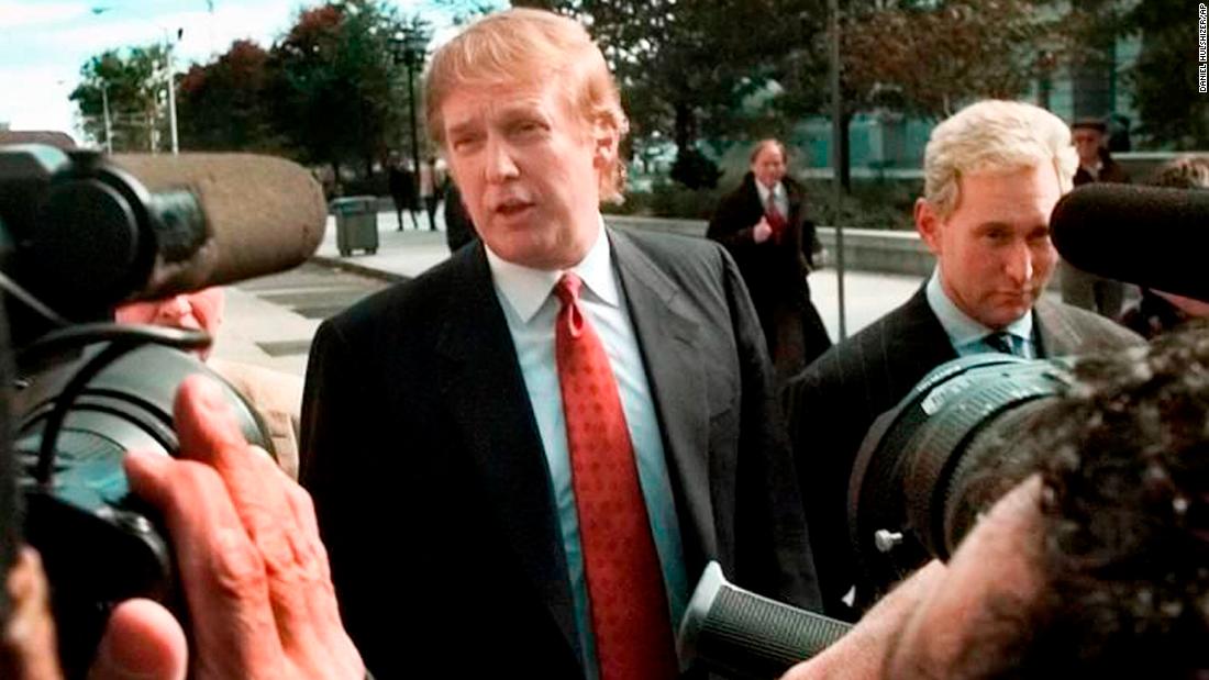 Donald Trump, next to Stone, speaks to reporters outside the federal courthouse in Newark, New Jersey, in October 1999. Stone was director of Trump&#39;s presidential exploratory committee. They were at the courthouse for the swearing-in of Trump&#39;s sister as a federal appeals court judge.