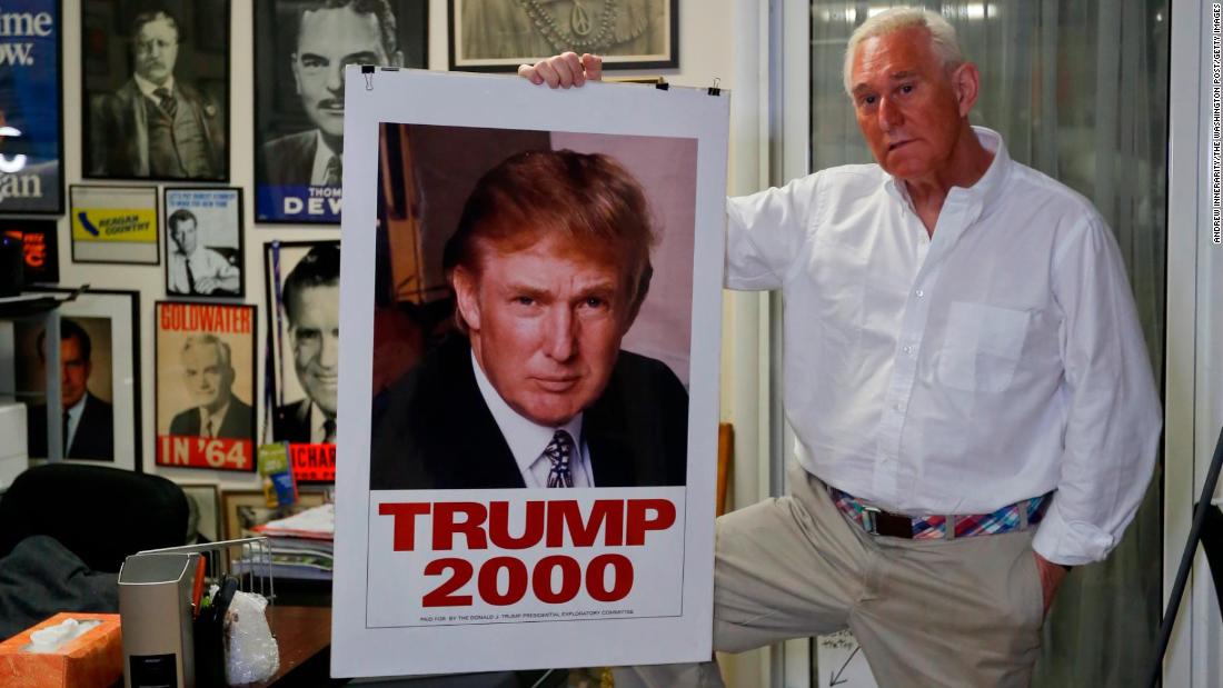 Stone poses with a 2000 poster of Donald Trump in his office in Florida.