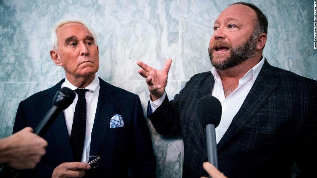 Stone and Alex Jones, the right-wing conspiracy theorist and talk-show host, speak to reporters outside the House Judiciary Committee in December 2018.