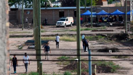 Police work in the lot next to the home of Gilad Pereg, where the bodies of his mother and aunt were found in Mendoza, Argentina, on Saturday.