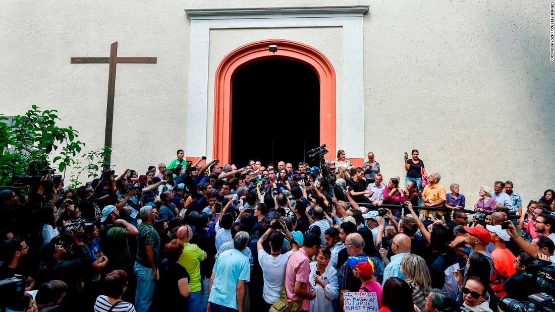 Guaido speaks to reporters after attending Mass in Caracas on Sunday, January 27.