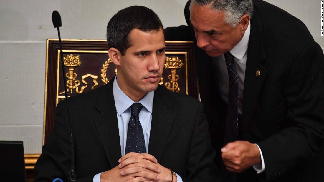 Guaido listens to deputy Rafael Veloz during a session at the National Assembly in Caracas on January 29. The Assembly met to debate a legal framework for creating a transitional government and calling new elections. Simultaneously, Venezuela&#39;s attorney general asked the Supreme Court to freeze Guaido&#39;s assets and bar him from leaving the country.