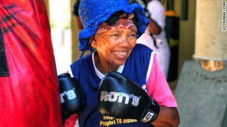 Gladys Ngwenya, 78, smiles during a boxing session at a gym in Cosmo City, South Africa.