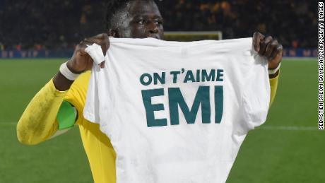Nantes defender Abdoulaye Toure holds a shirt which reads &#39;We love you Emiliano.&#39;