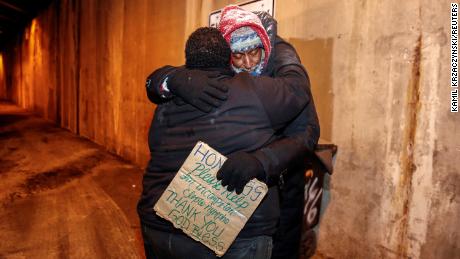 The Salvation Army's Richard S. Vargas hugs Alvin Henry during a cold wellness checkup in Chicago.