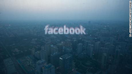 A photo taken on May 16, 2012 shows a computer screen displaying the logo of social networking site Facebook reflected in a window before the Beijing skyline. With investors hungry for Facebook shares ahead of a hotly anticipated offering, the social network unveiled a 25 percent increase in the number of shares to be sold at the market debut. AFP PHOTO / Ed Jones / AFP PHOTO / Ed Jones        (Photo credit should read ED JONES/AFP/Getty Images)