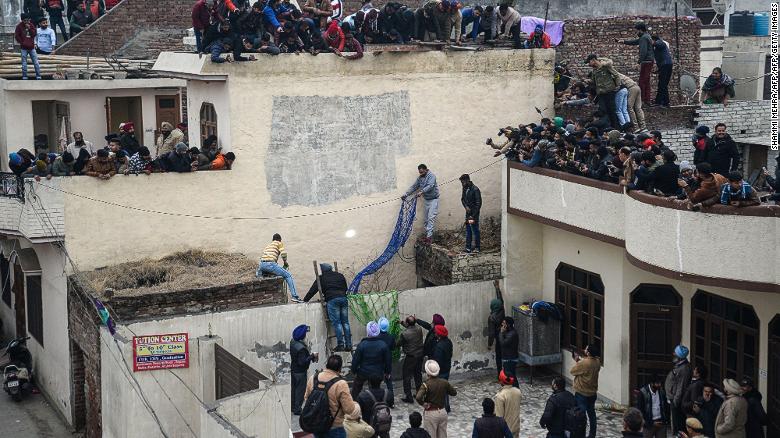 Forest Department workers try to catch a leopard that has attacked residents in Lamba village, on January 31, 2019. 