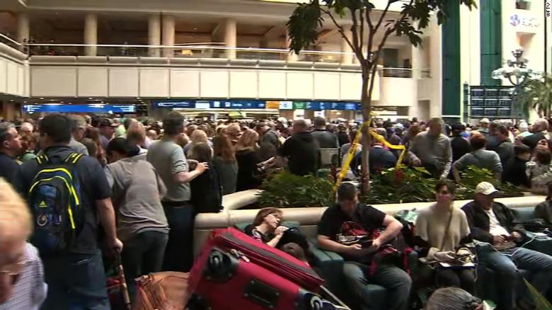 People pack lines at an Orlando airport security checkpoint Saturday after a TSA agent fell to his death.