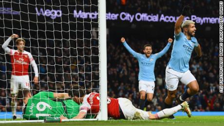 Sergio Aguero of Manchester City (right) celebrates after scoring his team&#39;s third goal during the Premier League match between Manchester City and Arsenal FC at Etihad Stadium on Sunday.  Aguero has scored 219 career goals for City, a team record. 