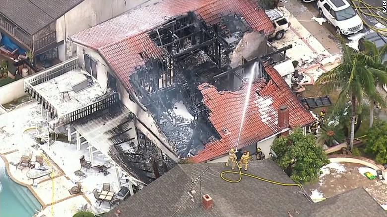 Firefighters work where a plane crashed into a home in Yorba Linda, California.