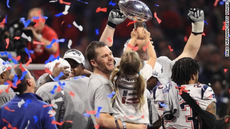 Tom Brady #12 of the New England Patriots celebrates with daughter Vivian who raises the Vince Lombardi Trophy after Super Bowl LIII.