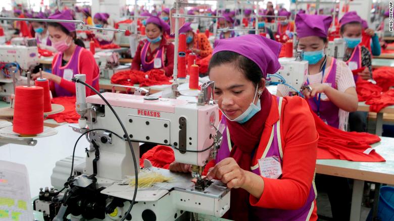 Garment workers sew clothes in a factory  outside of Phnom Penh, Cambodia, on August 30, 2017.  