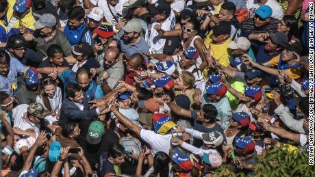 A crowd surrounds Juan Guaido during a protest against Maduro on Saturday.