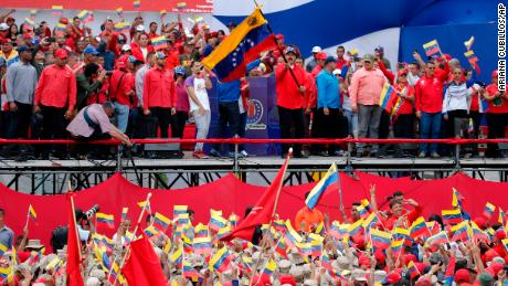 Venezuela's President Nicolas Maduro waves a national flag during a rally in Caracas, Venezuela, Saturday, Feb. 2, 2019.