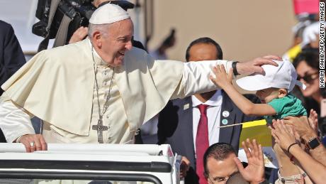 Pope Francis blesses a child as he arrives to lead mass for an estimated 170,000 Catholics at the Zayed Sports City Stadium on February 5, 2019. 