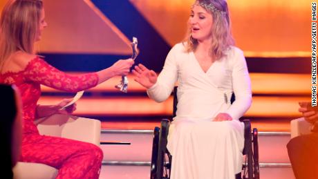 Vogel receives her award at the German athlete of the year ceremony from TV presenter Katrin Mueller-Hohenstein.