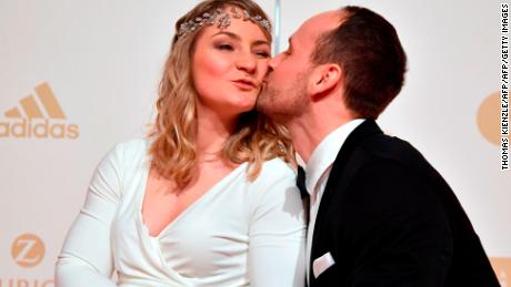 Vogel (L) and her partner German track cyclist Michael Seidenbecher pose upon arrival for the awards ceremony for "Germany's Sportsperson Athlete of the Year 2018" in Baden-Baden.