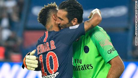 Paris Saint-Germain's Brazilian forward Neymar (L) hugs Paris Saint-Germain's Italian goalkeeper Gianluigi Buffon.