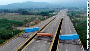 Tensions rise as Venezuela blocks Colombia border bridge in aid standoff
