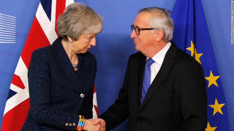 President of the European Commission Jean-Claude Juncker greets UK Prime Minister Theresa May in Brussels on Thursday.