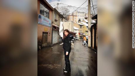 Shaparak Shajarizadeh stands unveiled in an Iranian town waving a white scarf on a stick, as part of the anti-compulsory hijab protests of 2018.
