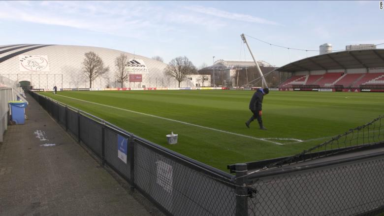 A groundsman prepares a pitch at Ajax&#39;s training ground.