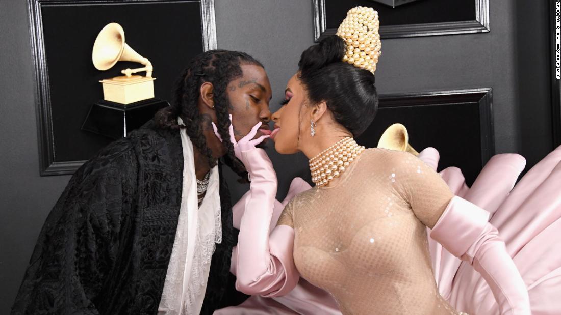 Cardi B and Offset kiss on the Grammys red carpet on Sunday, February 10.