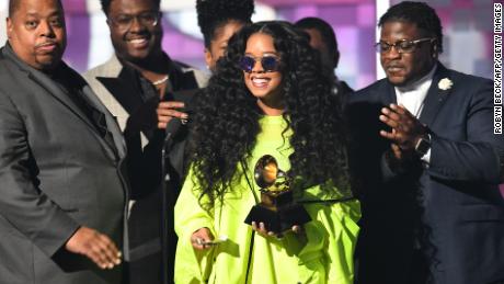 Gabriella Wilson (center), aka H.E.R., accepts the award for Best R&amp;B Album during the 61st Annual Grammy Awards in Los Angeles, February 10, 2019. 