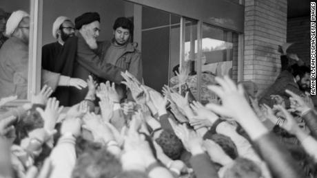 Ayatollah Rouhollah Khomeini greets the crowd at Tehran University after his return to Iran during the Iranian Revolution.