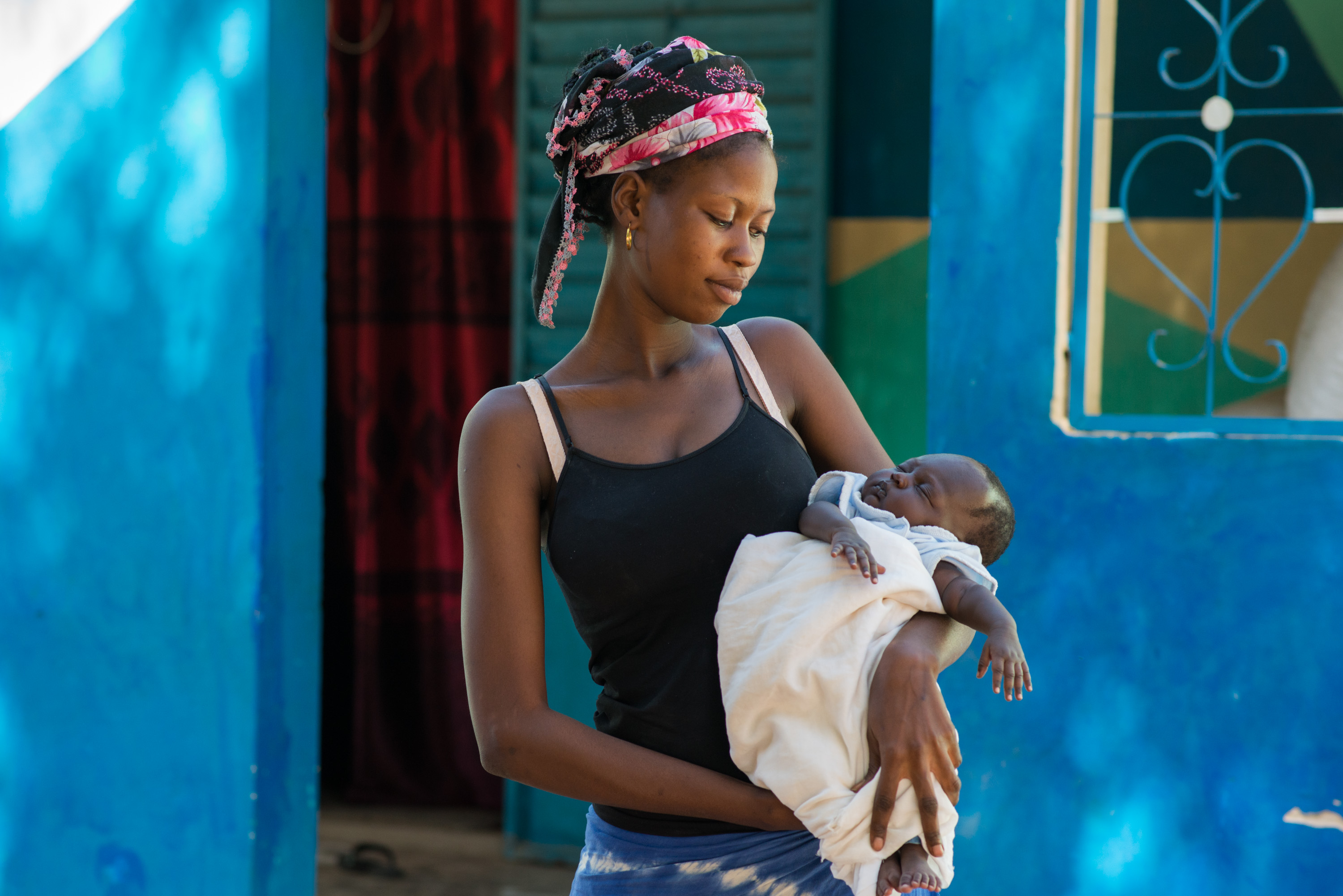 Aby Faye, 17, holds her two month old baby, Sokhna. Faye says she was aware of the importance of iodine during pregnancy thanks to Marie&#39;s campaigning in their village.