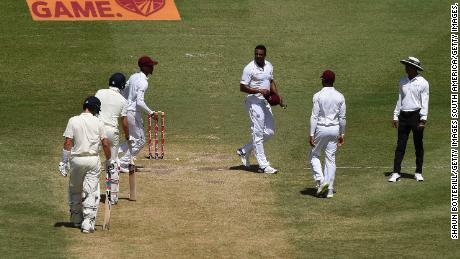 Shannon Gabriel of the West Indies exchanges words with Joe Root and Joe Denly of England.