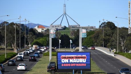 A billboard protesting the detention of children on Nauru sits outside of Parliament House on November 26 in Canberra.