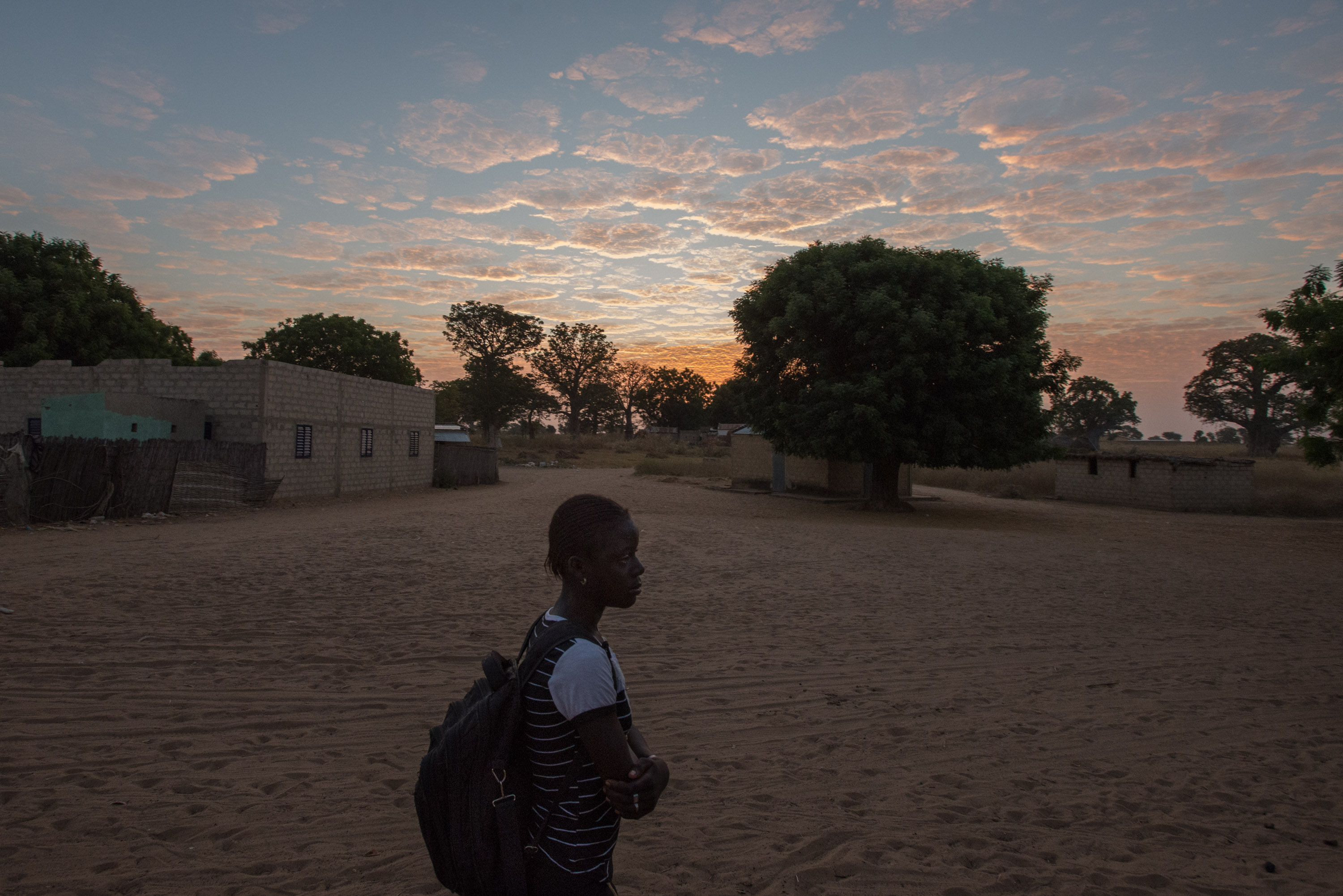 Marie&#39;s daughter Fatou, backpack in tow, sets off early one morning for school.