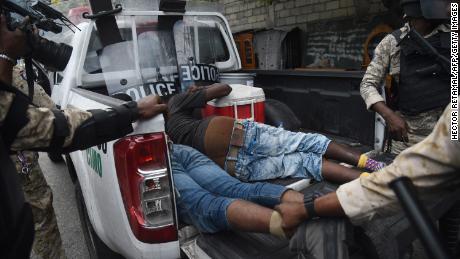 Haitian police arrest demonstrators during clashes in Port-au-Prince on Tuesday. 