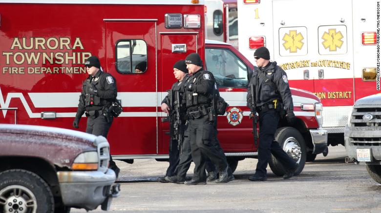 Police officers armed with rifles stage near a commercial building where an active shooter was reported in the 600 block of Archer Avenue in Aurora, Ill., Feb. 15, 2019. (Antonio Perez/Chicago Tribune/TNS)