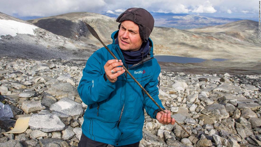 In Norway, archaeologists from a program called Secrets of the Ice are searching for items that melt out of ice patches. Pictured, a team member holds a 1,400-year-old arrow. 