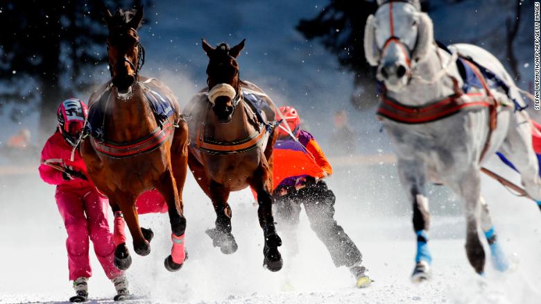 Competitors take part in the Skikjoering race at the White Turf horse racing event held on the frozen lake of the Swiss mountain resort of St. Moritz on February 17, 2019. - More images can be found on www.afpforum.com. Search slug: HORSE-RACING-SWITZERLAND (Photo by STEFAN WERMUTH / AFP)        (Photo credit should read STEFAN WERMUTH/AFP/Getty Images)