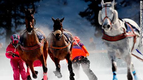 Competitors take part in the Skikjoering race at the White Turf horse racing event held on the frozen lake of the Swiss mountain resort of St. Moritz on February 17, 2019. - More images can be found on www.afpforum.com. Search slug: HORSE-RACING-SWITZERLAND (Photo by STEFAN WERMUTH / AFP)        (Photo credit should read STEFAN WERMUTH/AFP/Getty Images)