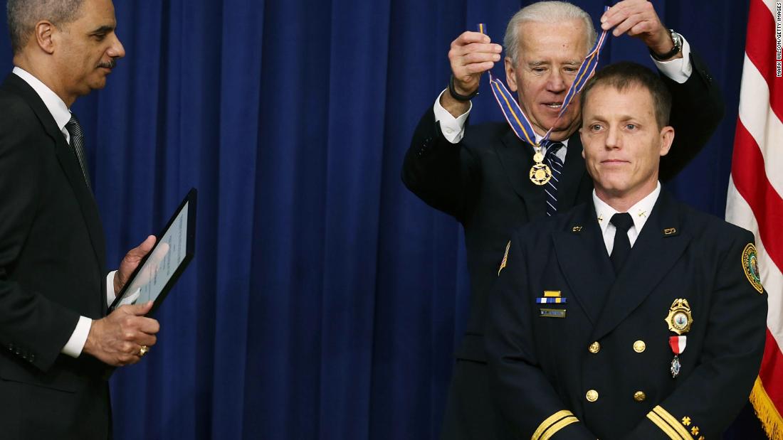 Biden awards the Medal of Valor to William Reynolds, a battalion chief with the Virginia Beach Fire Department, during a ceremony in Washington, DC, in February 2013. Biden presented the award to public safety officers who had exhibited exceptional courage, regardless of personal safety, in the attempt to save or protect others from harm.