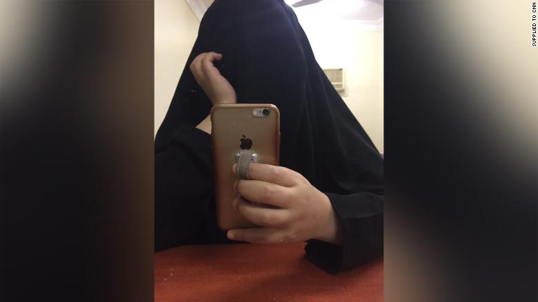 The younger sister takes a selfie in a hotel room. They say they felt like &quot;ghosts&quot; under the full-length black robe, as if they were invisible, not there. 