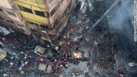 Firefighters are seen at the scene of a fire in Dhaka on February 21, 2019. 