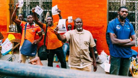 Supporters of Ousmane Sonko leafletting ahead of the election. 