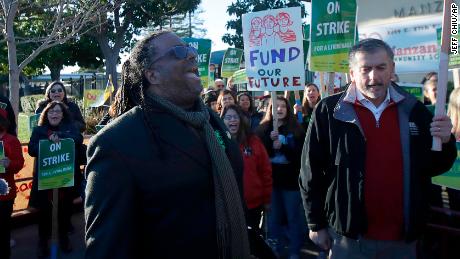 Teachers' union president Keith Brown yells after speaking outside of a school in Oakland on February 21. 