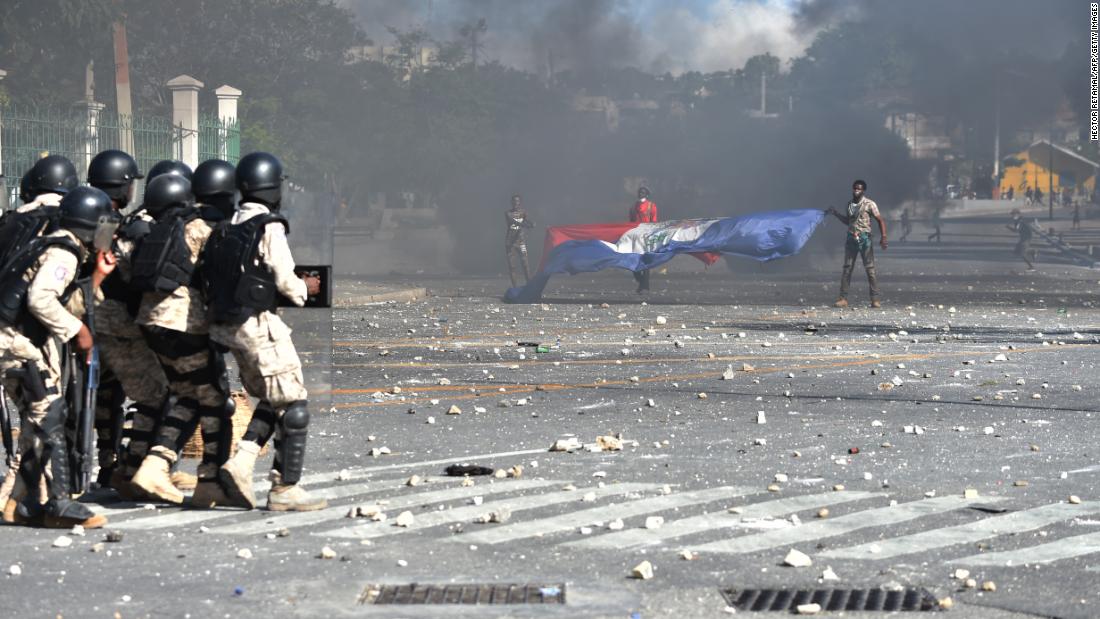 Police try to break up a protest in front of the National Palace in Port-au-Prince on February 13.