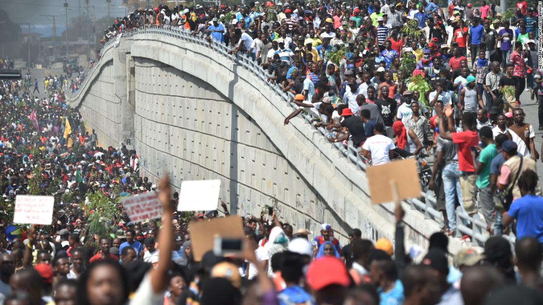 Demonstrators march through the streets of Port-au-Prince, Haiti, on Thursday, February 7, demanding the resignation of Haitian President Jovenel Moise.