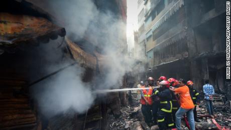 Firefighters try to extinguish a fire in Dhaka on February 21, 2019. 