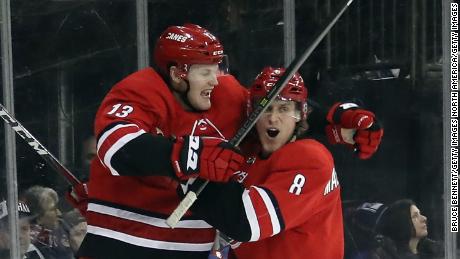 Warren Foegele, left, of the Carolina Hurricanes celebrates a game-winning goal in a February match.