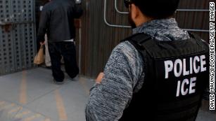 U.S. Immigration and Customs Enforcement (ICE) agents look on as an undocumented man is received by a Mexican immigration agent at a removal gate of the U.S.-Mexico border in San Diego, California, U.S., on Thursday, Feb. 26, 2015. The U.S. Department of Homeland Security is nearing a partial shutdown as the agency's funding is set to expire Friday -- something Senate Majority Leader Mitch McConnell had said wouldn't happen on his watch. Photographer: David Maung/Bloomberg via Getty Images