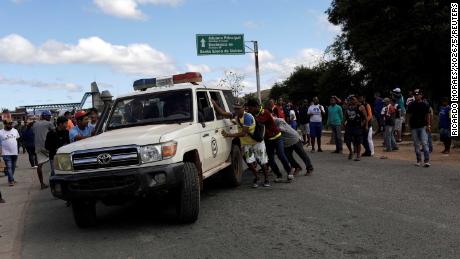 An ambulance carries people injured in clashes Friday in southern Venezuela near the Brazilian border.