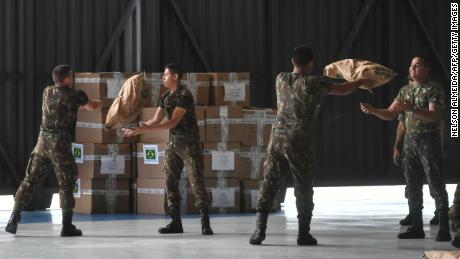 Brazilian soldiers organize sacks of powdered milk Friday in Boa Vista in humanitarian aid for Venezuela.